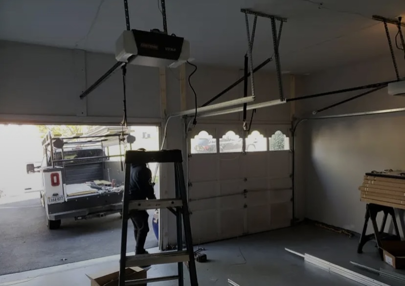 Garage Door Maintenance with man in front of ladder
